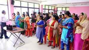Indian woman dressed in colourful sarees attending face-to-face session for the learning in a digital age course.